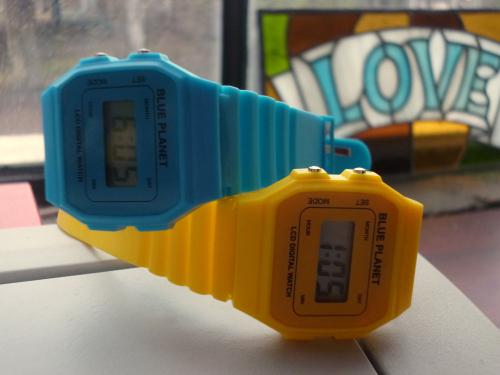 Blue and Yellow digital watches displaying different times